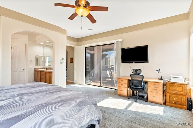 bedroom featuring light carpet, visible vents, arched walkways, access to outside, and a sink