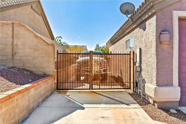 view of gate with fence