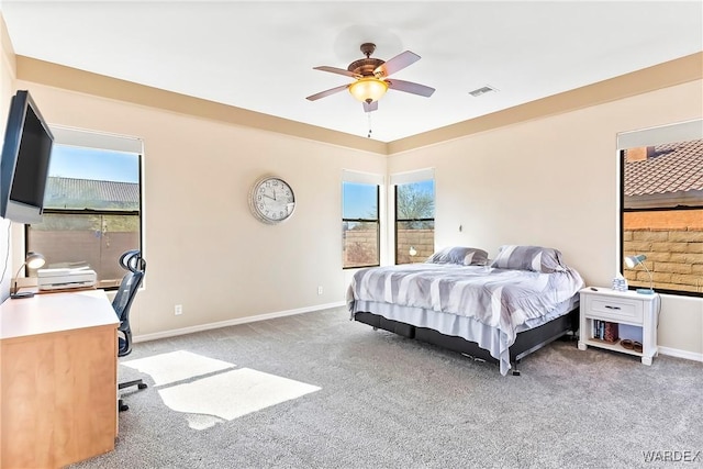 bedroom featuring carpet floors, baseboards, multiple windows, and visible vents