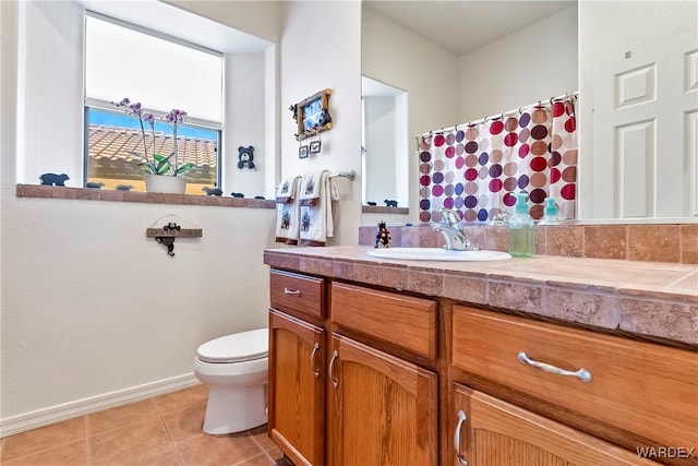 bathroom featuring toilet, tile patterned flooring, and vanity