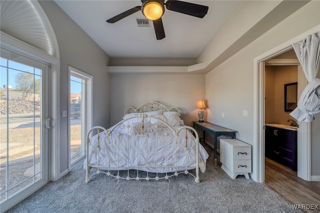 bedroom featuring access to exterior, visible vents, ceiling fan, and wood finished floors