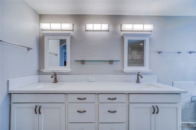 full bathroom with double vanity and a sink