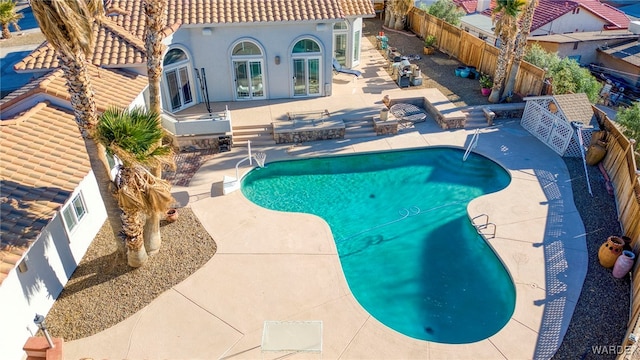 view of pool featuring a patio, a fenced backyard, and a fenced in pool