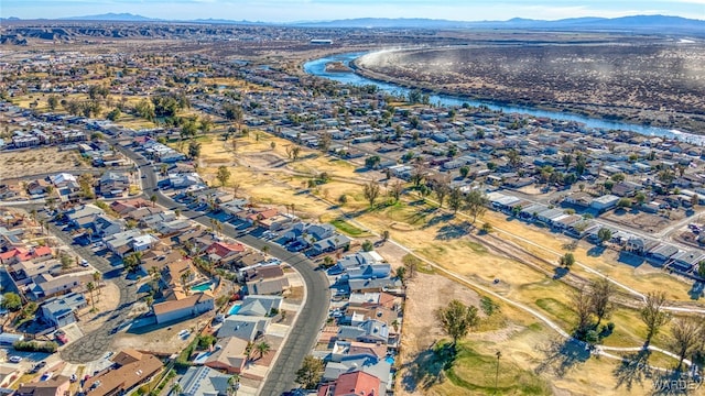 drone / aerial view featuring a residential view and a water and mountain view