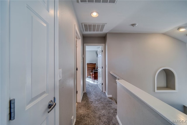 corridor featuring recessed lighting, visible vents, dark carpet, and baseboards