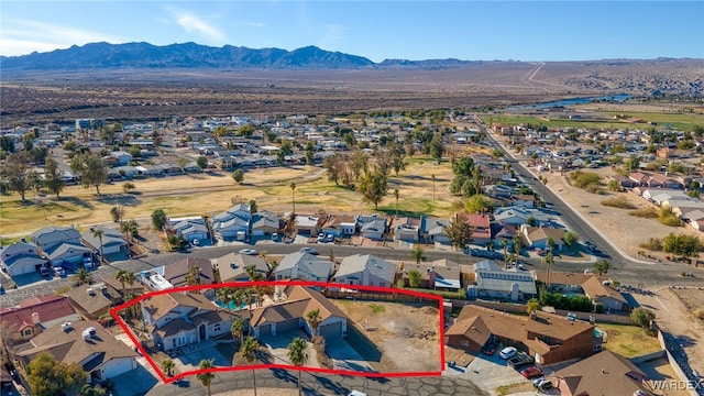 drone / aerial view featuring a residential view and a mountain view