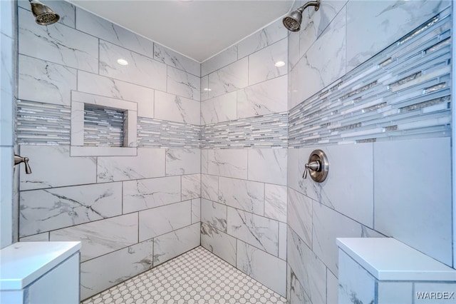 full bathroom featuring tiled shower