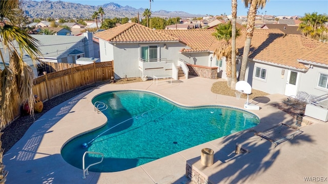 view of swimming pool with a fenced in pool, a patio area, a mountain view, a residential view, and a fenced backyard