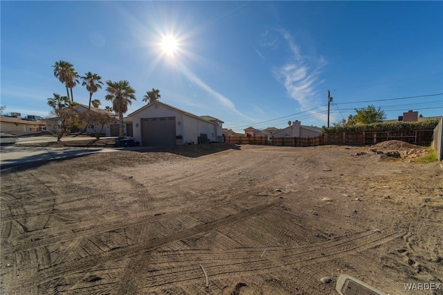 view of yard with a garage and fence