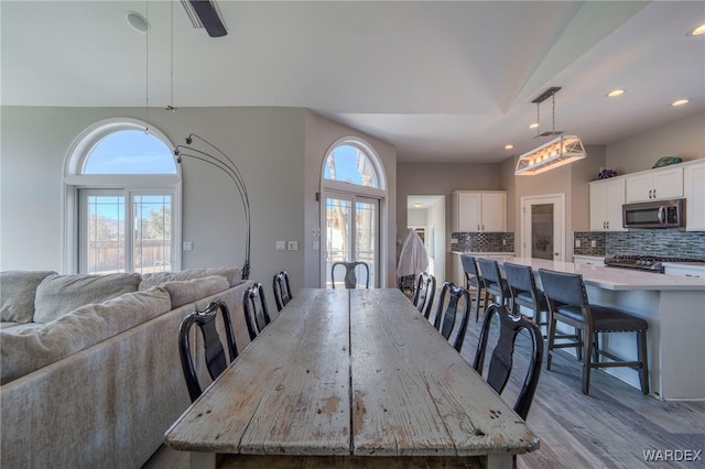 dining room with recessed lighting and light wood-style flooring