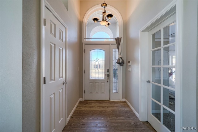 entryway featuring dark wood-style flooring and baseboards