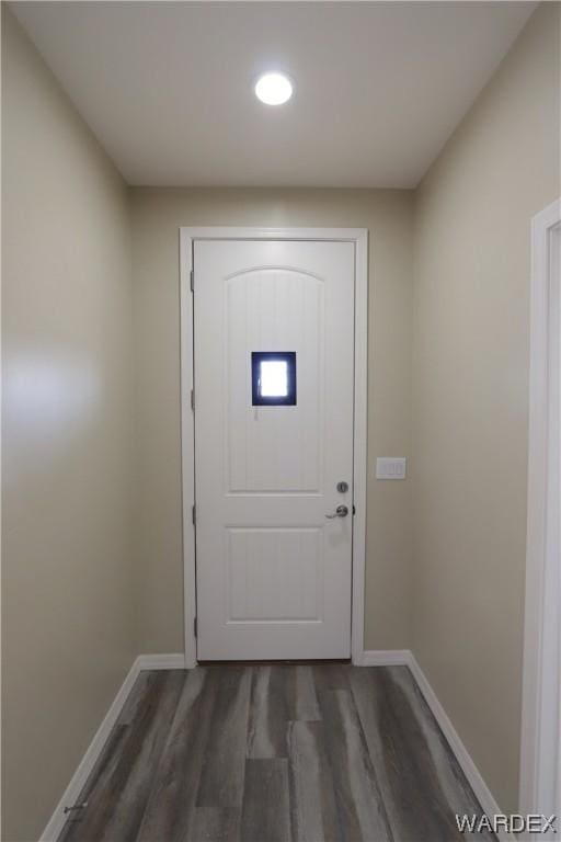 doorway to outside featuring dark wood finished floors and baseboards