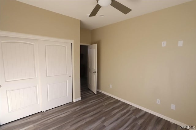 unfurnished bedroom featuring a closet, baseboards, ceiling fan, and dark wood-style flooring