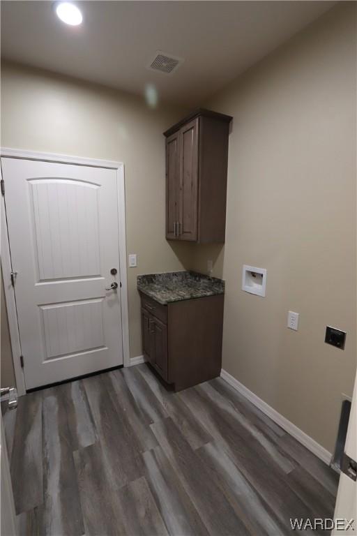 clothes washing area featuring cabinet space, visible vents, dark wood-style floors, hookup for a washing machine, and hookup for an electric dryer