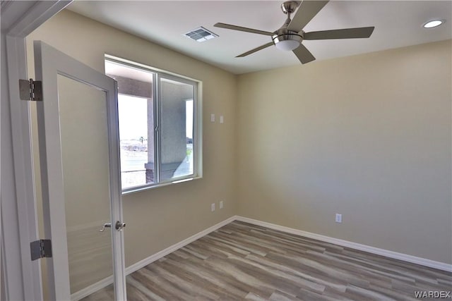 spare room featuring baseboards, visible vents, a ceiling fan, light wood-type flooring, and recessed lighting