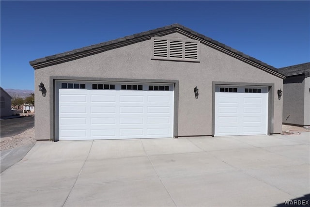 garage with concrete driveway