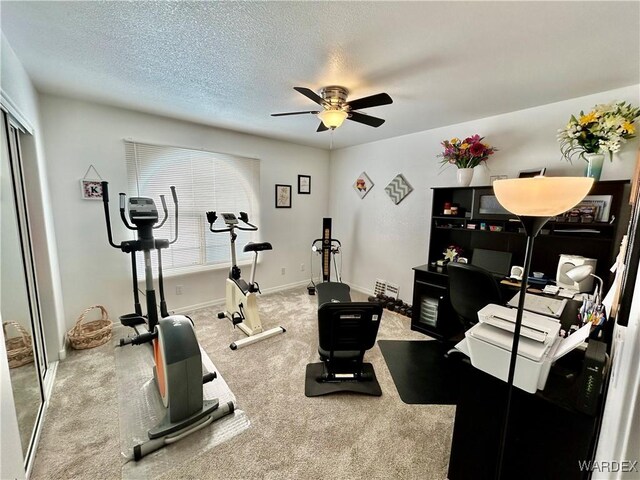 workout room featuring carpet flooring, ceiling fan, a textured ceiling, and baseboards