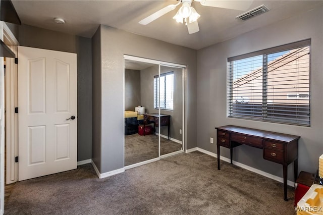 bedroom featuring a closet, visible vents, dark carpet, and baseboards