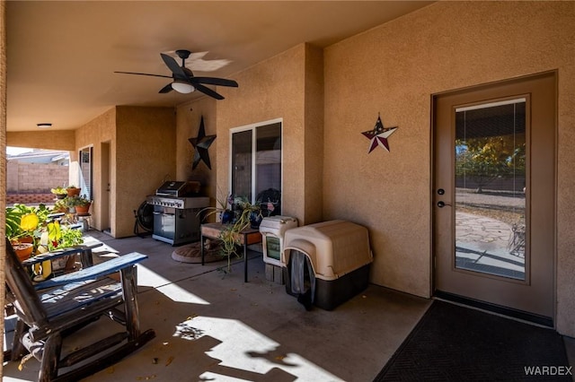 view of patio featuring fence, grilling area, and a ceiling fan