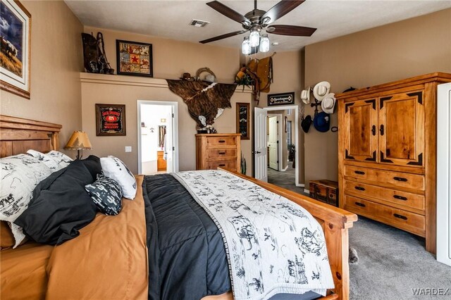 bedroom featuring a ceiling fan, visible vents, connected bathroom, and light colored carpet