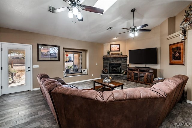 living room featuring lofted ceiling, visible vents, dark wood finished floors, and ceiling fan