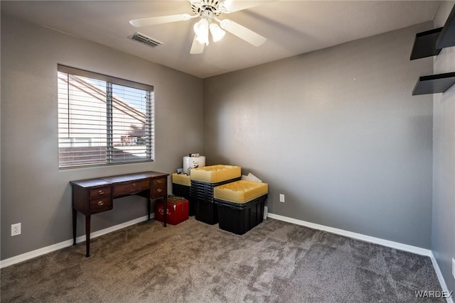 interior space with baseboards, visible vents, dark colored carpet, and a ceiling fan