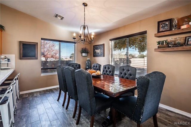 dining space with an inviting chandelier, visible vents, baseboards, and dark wood-type flooring