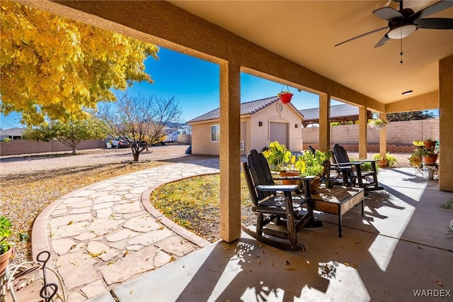 view of patio / terrace with ceiling fan, a fenced backyard, and outdoor dining area