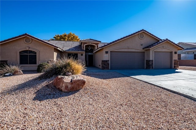 view of front of property featuring stone siding, concrete driveway, an attached garage, and stucco siding