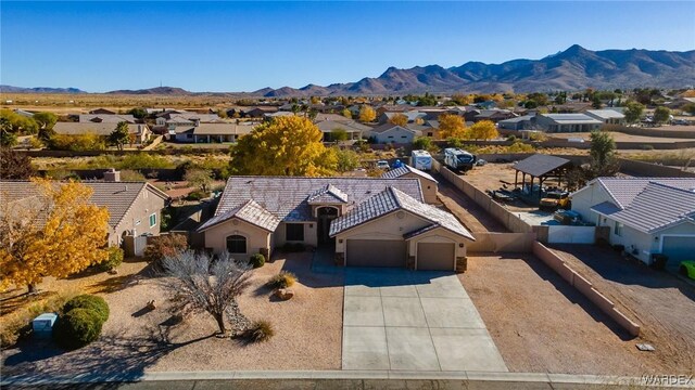 drone / aerial view featuring a residential view and a mountain view