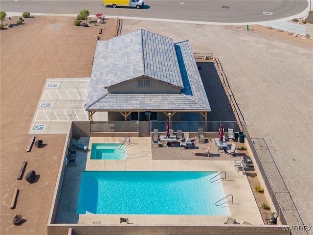 community pool with fence and a patio