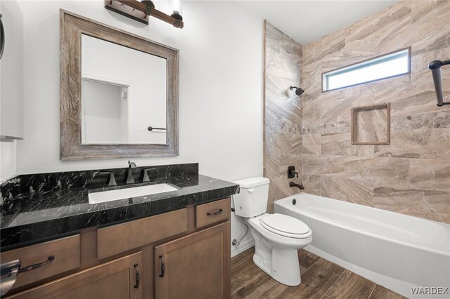 full bath with shower / washtub combination, vanity, toilet, and wood finished floors