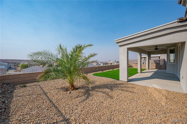 view of yard with a patio, a fenced backyard, and a ceiling fan