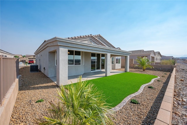 rear view of property featuring a patio area, a fenced backyard, central AC unit, and stucco siding