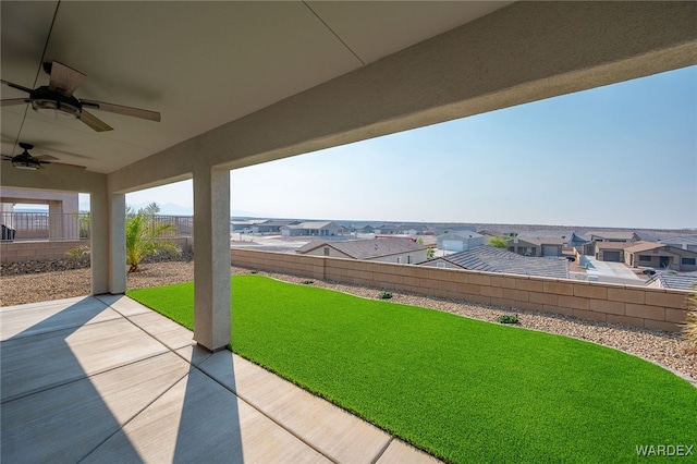 view of patio / terrace featuring a ceiling fan, a residential view, and a fenced backyard