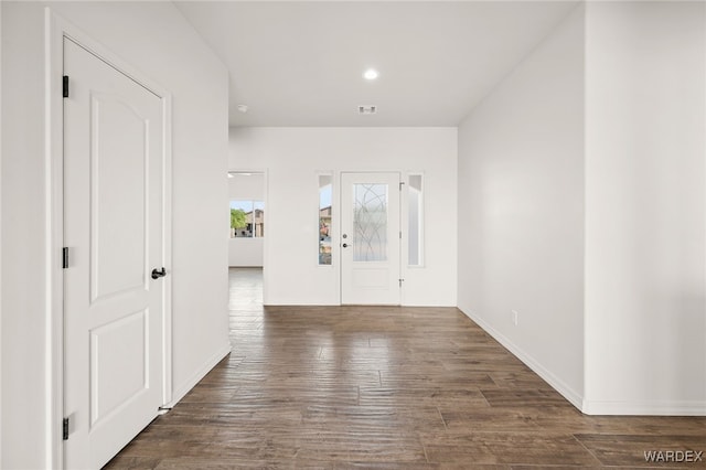 entrance foyer featuring baseboards, visible vents, dark wood finished floors, and recessed lighting