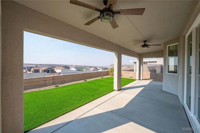 view of patio with a residential view, a fenced backyard, and ceiling fan