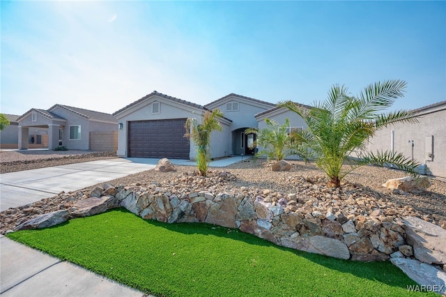 view of front of property with driveway, a garage, and stucco siding