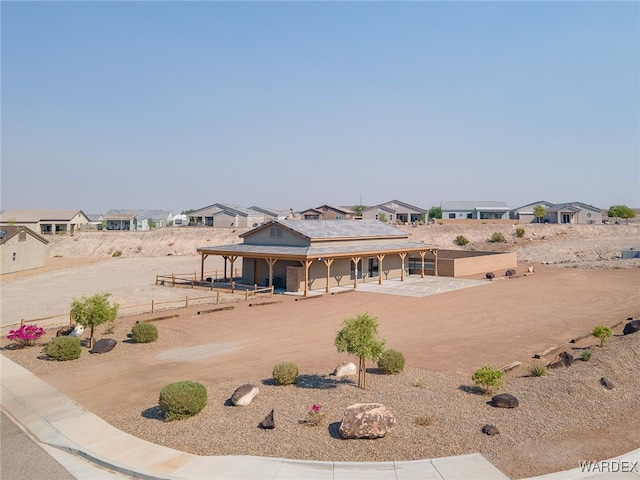 view of front of property with fence and a residential view