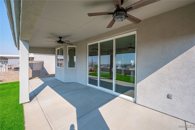 view of patio / terrace featuring fence and a ceiling fan