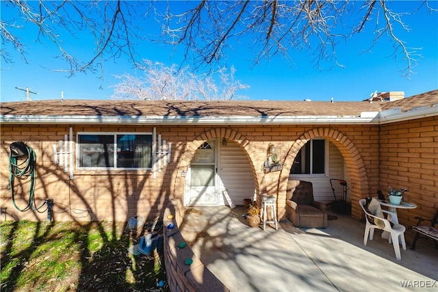 back of property featuring a patio area and brick siding