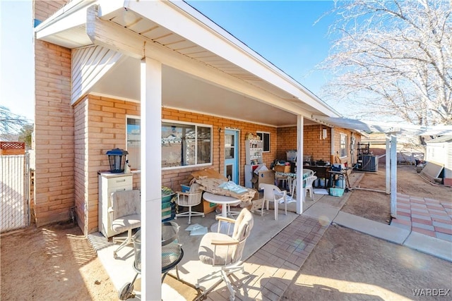 view of patio featuring central AC unit and fence