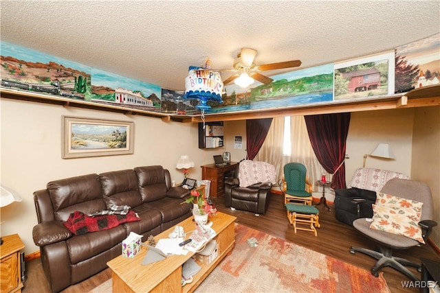 living room with a textured ceiling, a ceiling fan, and wood finished floors