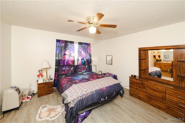 bedroom with light wood-style flooring, ceiling fan, and a textured ceiling