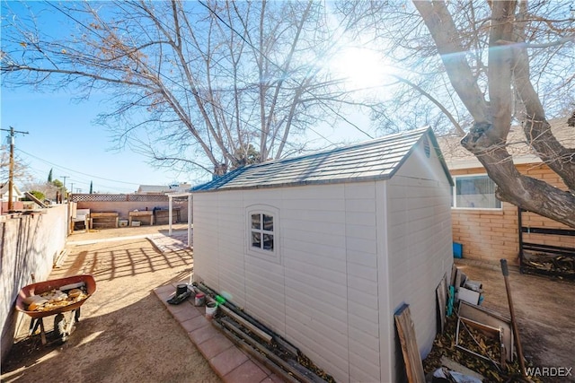 view of shed with a fenced backyard