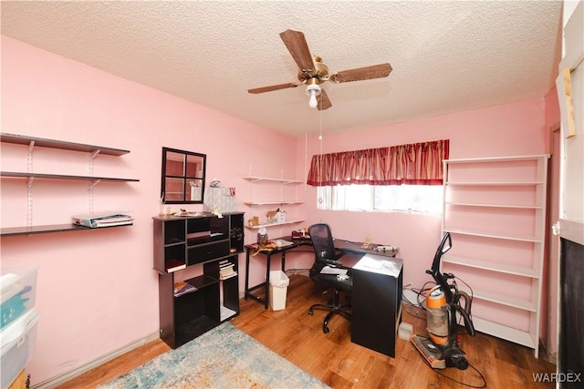 home office featuring ceiling fan, a textured ceiling, and wood finished floors