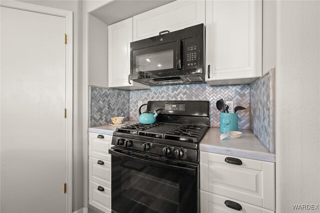 kitchen featuring white cabinets, black appliances, and light countertops