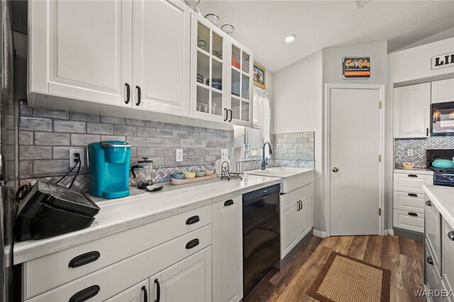 kitchen featuring glass insert cabinets, light countertops, black appliances, and white cabinetry