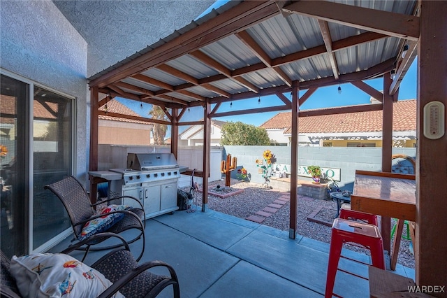 view of patio with a fenced backyard and a grill