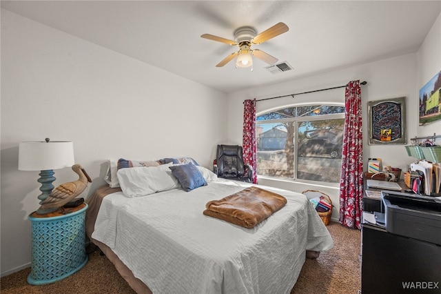 carpeted bedroom with a ceiling fan and visible vents